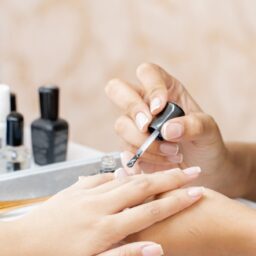 a woman is doing a manicure on a child's hand