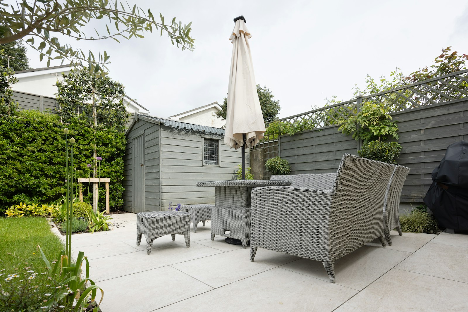 A patio with a table and chairs and an umbrella