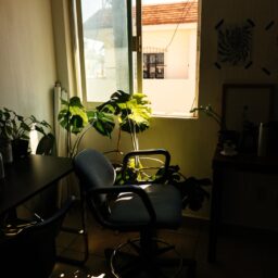 a chair sitting in a room next to a window