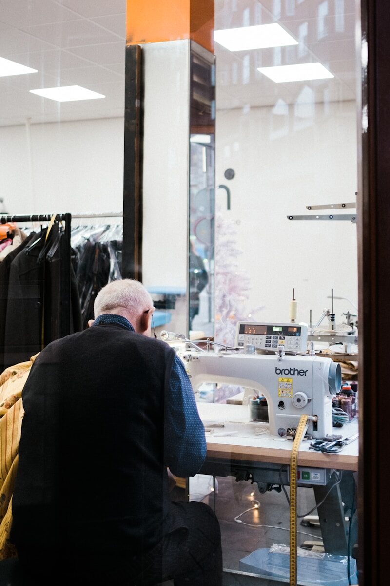 sitting man sewing